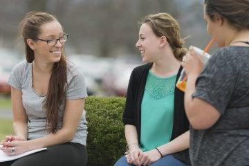 Campus Scenic - Students Talking by bushes - Spring 062